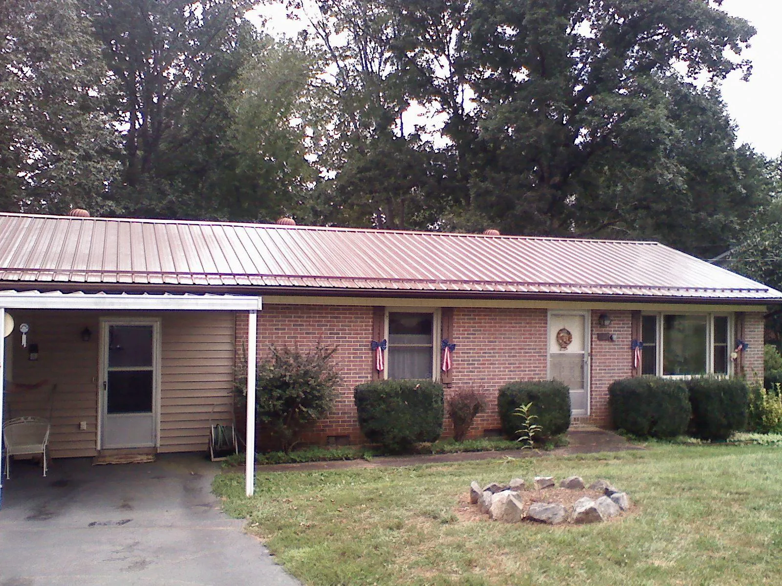 Bronze metal roof and carport on a brick ranch home — Roof Repair work by our crew in Rock Tavern